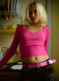 Blonde haired beauty does a strip tease in her apartment..
